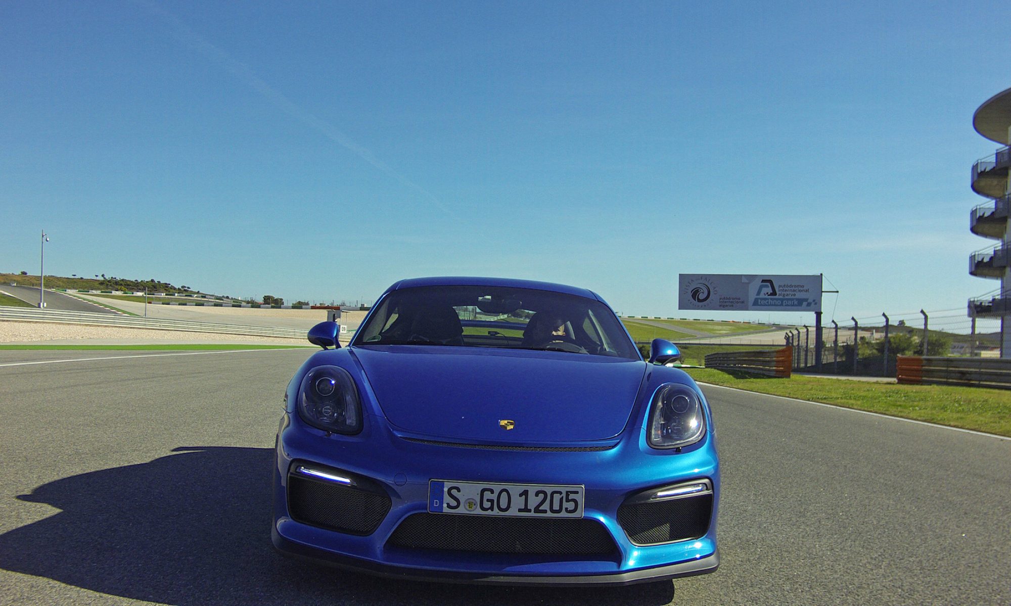 Blue Porsche Cayman GT4 on the Algarve circuit