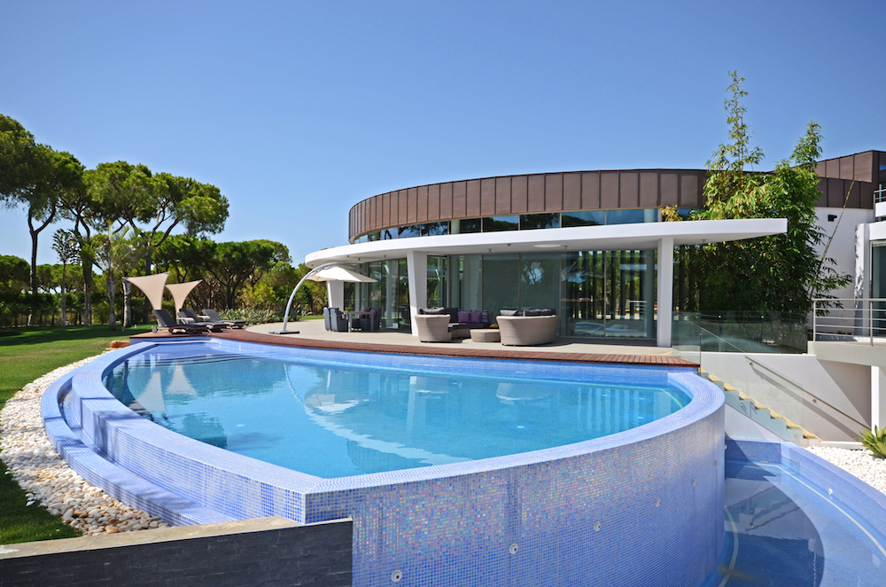 Aerial view of a modern property with infinity pool